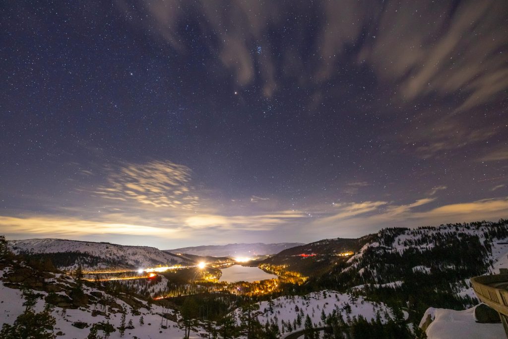 A captivating night view of Donner Pass and Lake under a starry sky.